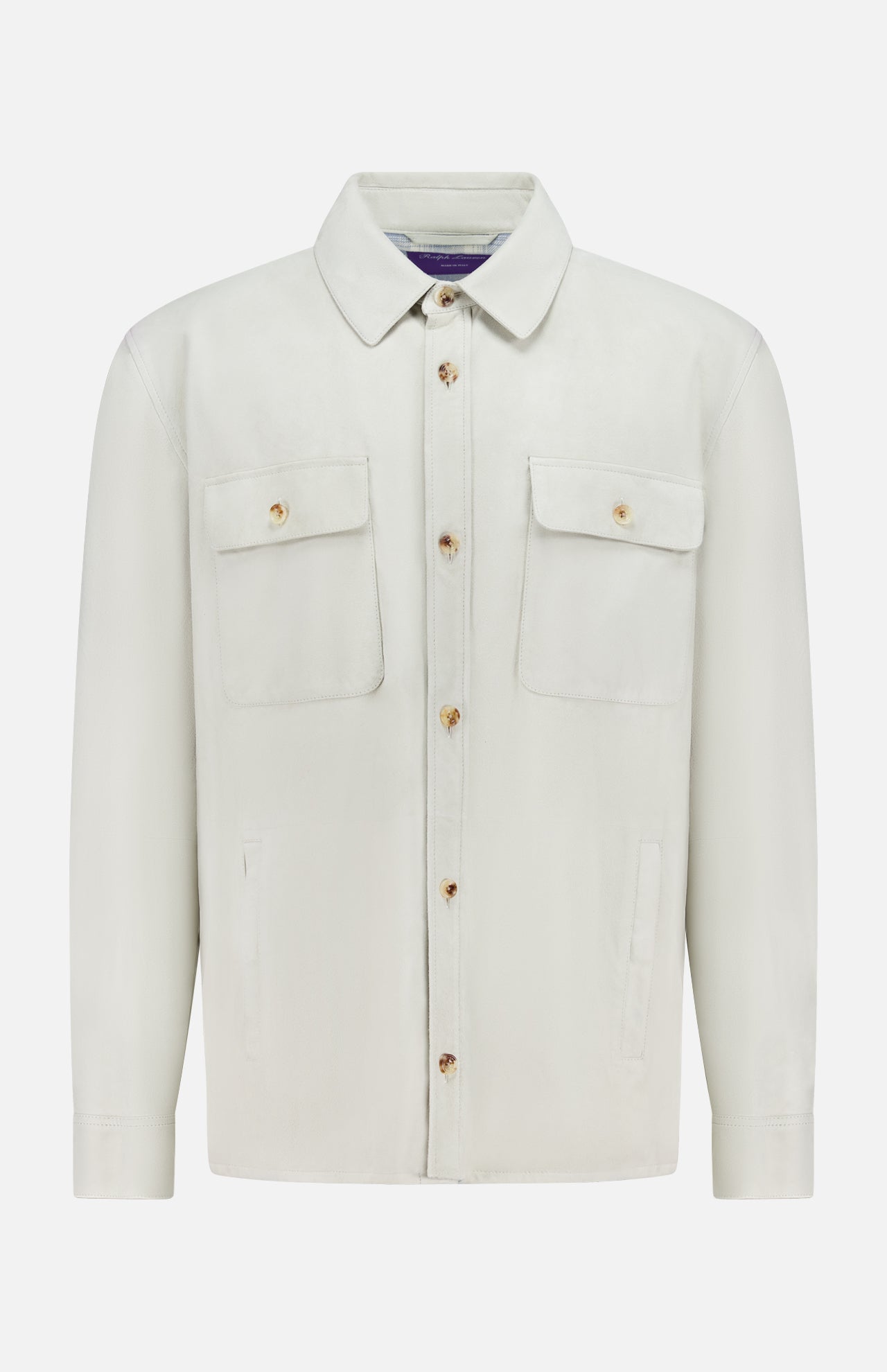 The Calloway Suede Knit Overshirt by RALPH LAUREN PURPLE LABEL is a light beige shirt jacket featuring a collar, two chest flap pockets with buttons, and two vertical side pockets. Displayed on a plain white background, this piece exemplifies exceptional Italian craftsmanship.