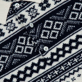 Close-up of the RALPH LAUREN PURPLE LABEL Cash Holiday Pattern Polo Sweater in cream, featuring navy blue Nordic-inspired geometric designs and three Mother of Pearl buttons on the front placket.