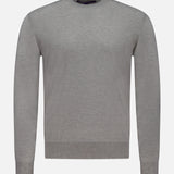 The RALPH LAUREN PURPLE LABEL Cashmere Crewneck Pullover Sweater, shown against a white background, features a plain light gray design with ribbed cuffs, hem, and collar. Expertly crafted in Italy, this long-sleeve sweater offers timeless simplicity and elegance.