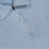 A pale blue Cashmere Long Sleeve Quarter Zip Polo Sweatshirt by RALPH LAUREN PURPLE LABEL, featuring a collar, partial front zipper, and a distinctive purple “Ralph Lauren Made in Italy” tag. This men’s casual sweatshirt offers refined comfort and effortless style with its subtle embroidered design on the right side.