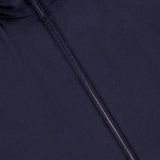 Close-up of the RALPH LAUREN PURPLE LABEL Compact Unlined Cashmere Vest in navy, featuring a partially unzipped front and raised collar. Made in Italy, this vest highlights an expertly crafted, smooth cashmere texture for refined style.