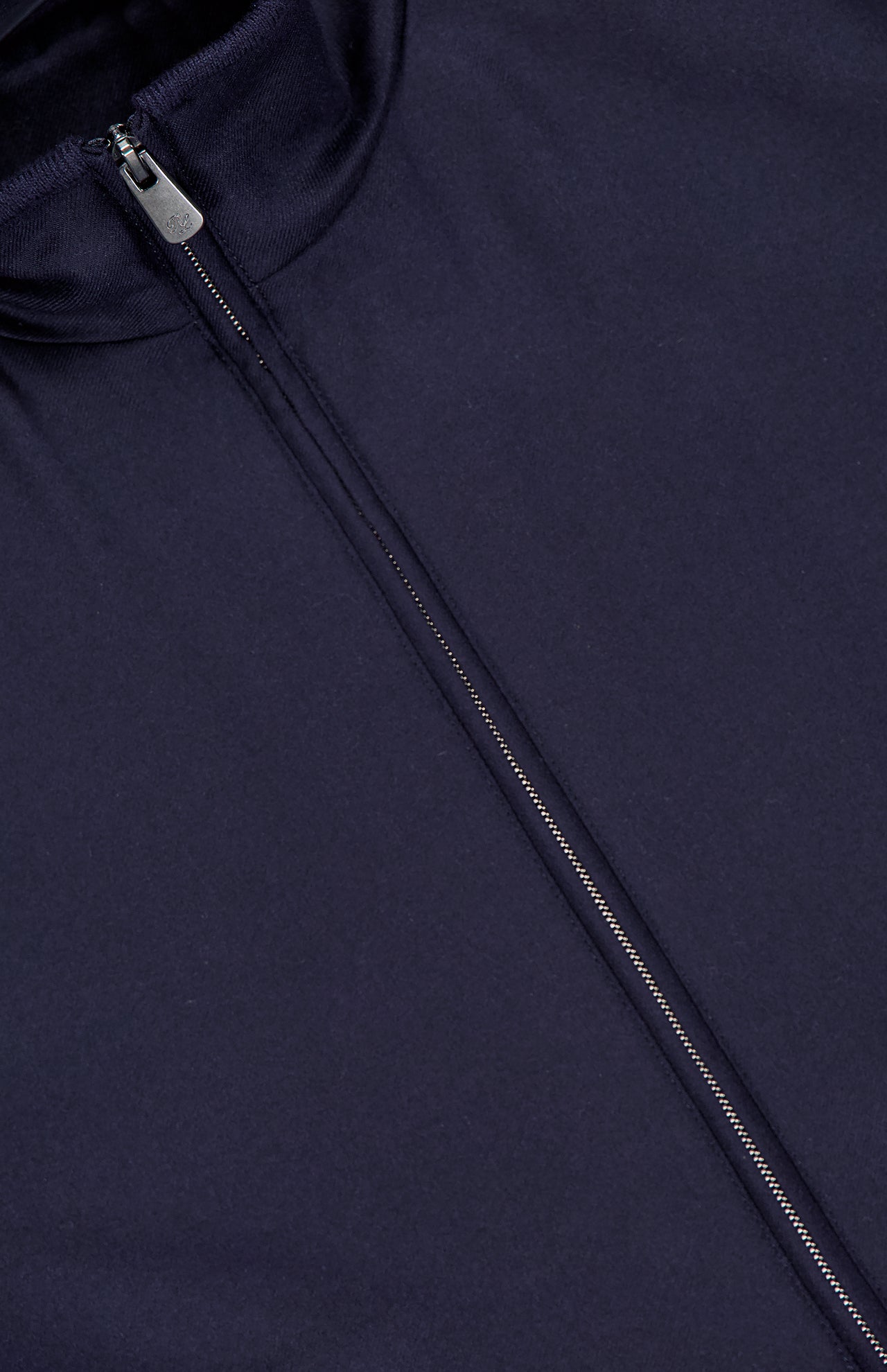 Close-up of the RALPH LAUREN PURPLE LABEL Compact Unlined Cashmere Vest in navy, featuring a partially unzipped front and raised collar. Made in Italy, this vest highlights an expertly crafted, smooth cashmere texture for refined style.