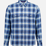 The Cooper Cotton Plaid Sport Shirt by RALPH LAUREN PURPLE LABEL features a blue and white plaid pattern, long sleeves, a collar, and two chest pockets. It is displayed against a plain light background.