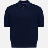 The Cotton Short Sleeve Polo Pullover Sweater by RALPH LAUREN PURPLE LABEL is a navy blue knit polo featuring a textured pattern, ribbed cuffs and hem, a pointed collar, and a three-button placket. Crafted in Italy from soft cotton sweater material, it is showcased against a plain white background.