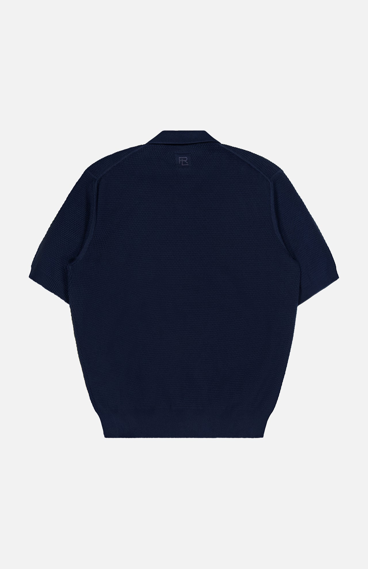 A navy blue Cotton Short Sleeve Polo Pullover Sweater by RALPH LAUREN PURPLE LABEL is displayed from the back, highlighting a subtle textured pattern and a small logo near the neckline. Expertly crafted in Italy, this piece blends understated elegance with superior craftsmanship.