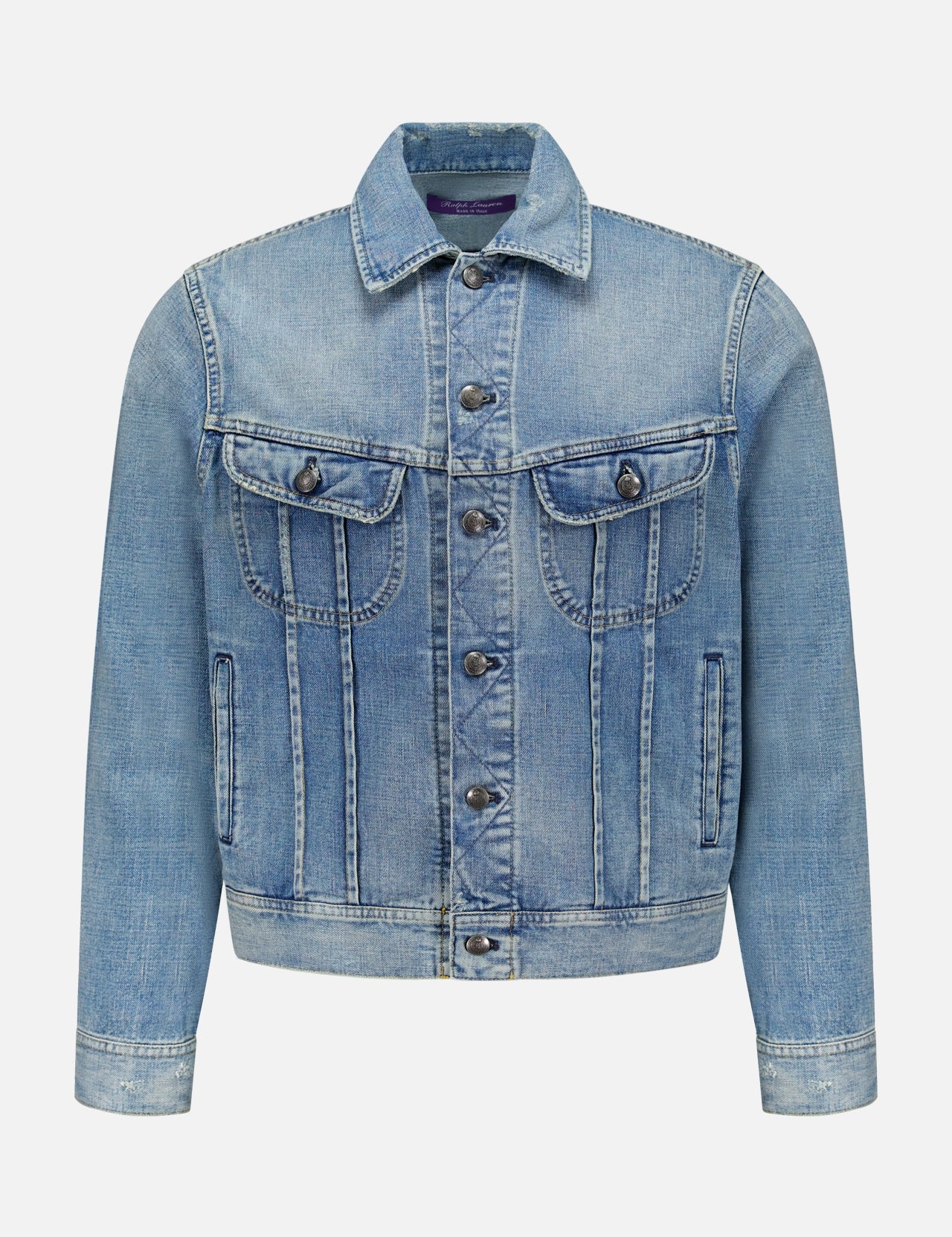 The Lux Italian Denim Trucker Jacket by RALPH LAUREN PURPLE LABEL features light blue Japanese denim with metal buttons, front chest pockets with flaps, side pockets, and visible seams. Showcasing a subtle vintage fade, this Purple Label jacket is displayed against a plain white background.