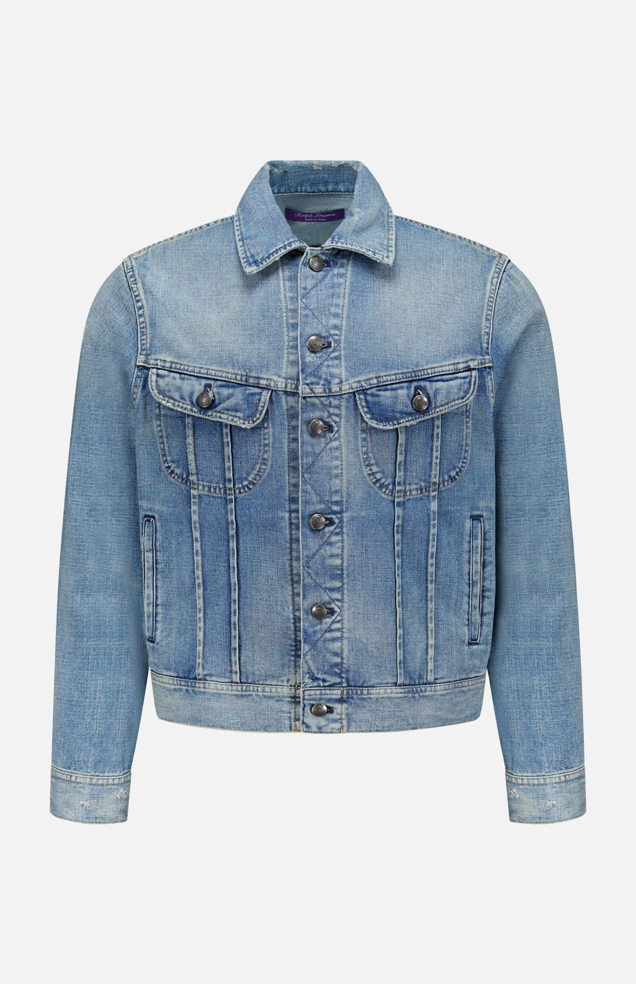 The Lux Italian Denim Trucker Jacket by RALPH LAUREN PURPLE LABEL features light blue Japanese denim with metal buttons, front chest pockets with flaps, side pockets, and visible seams. Showcasing a subtle vintage fade, this Purple Label jacket is displayed against a plain white background.