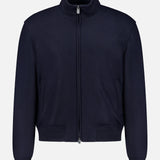 The Double Faced Cashmere Felton Bomber Jacket by RALPH LAUREN PURPLE LABEL is a luxurious navy zip-up with a high collar, long sleeves, and ribbed cuffs and hem, showcased against a plain white background. Drawing inspiration from classic Ralph Lauren designs, this piece offers timeless sophistication for any wardrobe.