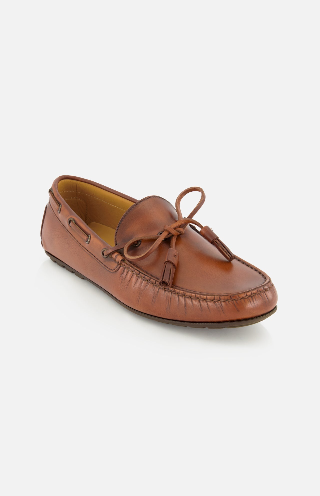 The Harold Hand Burnished Tassle Loafer by RALPH LAUREN PURPLE LABEL is a single brown loafer crafted from luxurious French box calfskin, featuring a classic tassel detail on top, visible stitching, and an easy slip-on design, displayed on a white background.