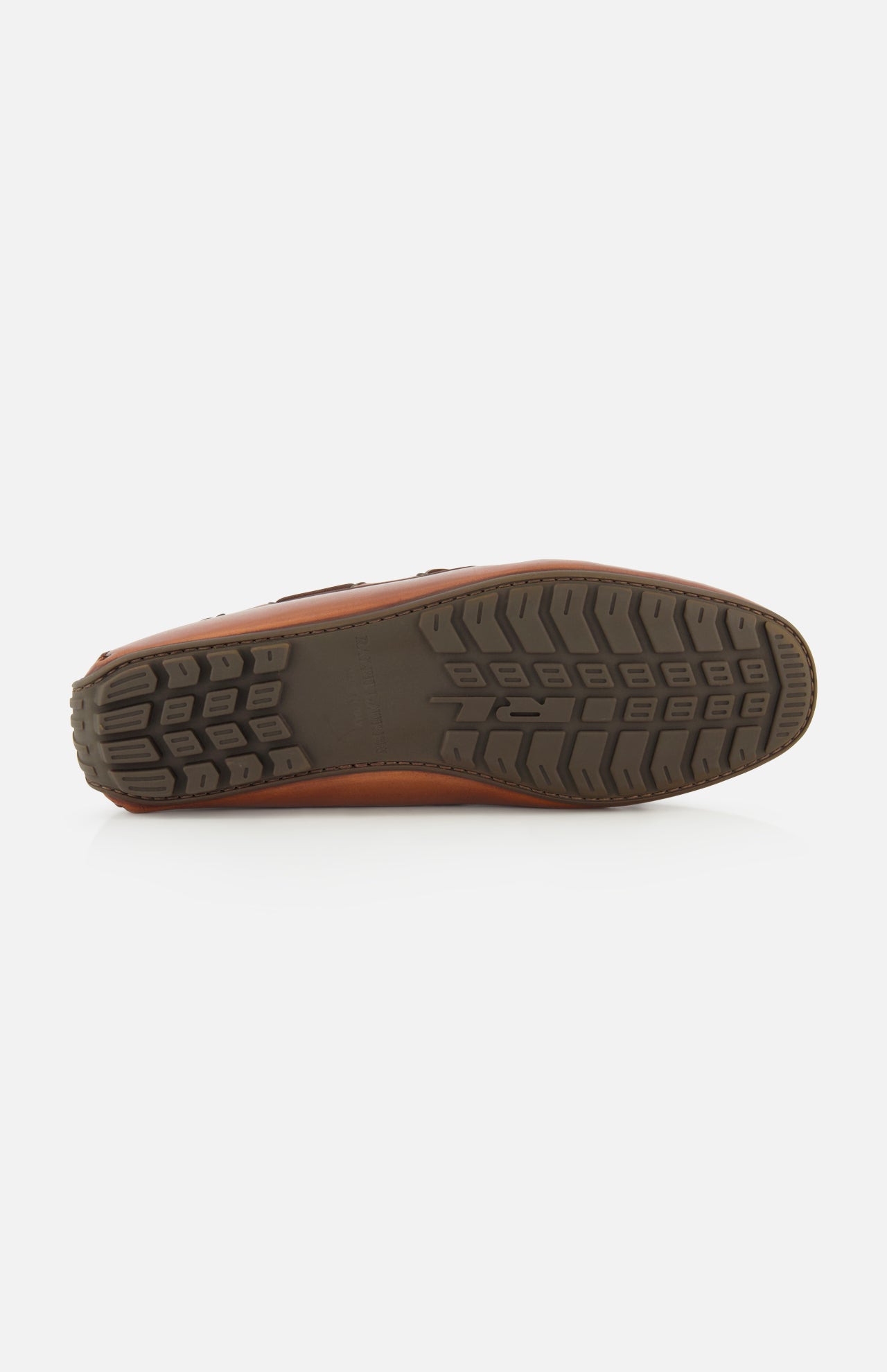 The image displays the bottom sole of the Harold Hand Burnished Tassle Loafer by RALPH LAUREN PURPLE LABEL, featuring a brown leather upper and a black, patterned rubber tread shown facing upward against a plain white background.