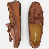 Presenting the Harold Hand Burnished Tassle Loafer from RALPH LAUREN PURPLE LABEL: a pair of brown leather loafers crafted from premium French box calfskin, featuring hand-applied burnishing, visible stitching, and refined rubber sole details. Shown from above and the side, these timeless slip-ons with elegant tassels combine sophistication and comfort for any occasion.
