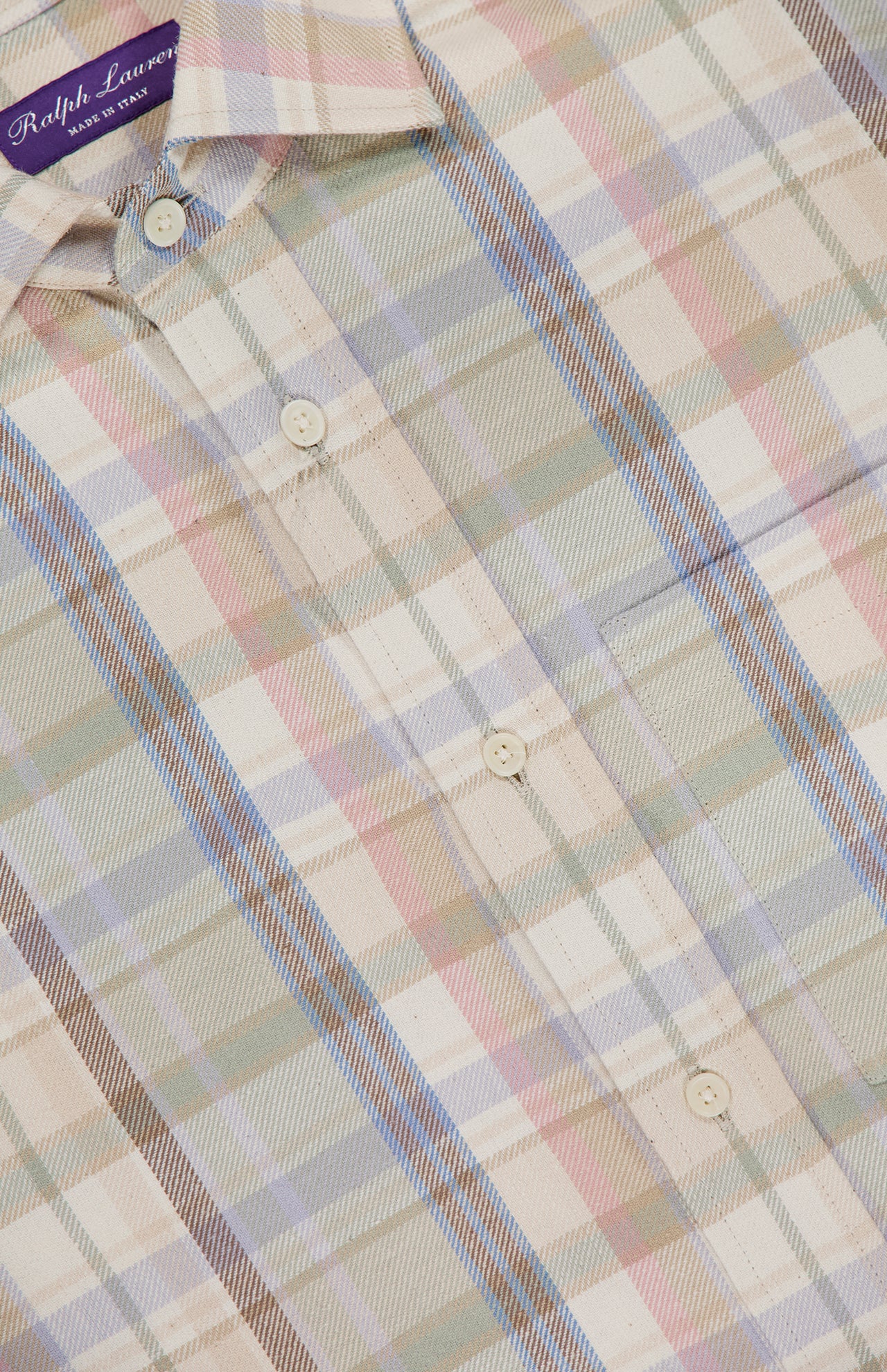 A close-up of the RALPH LAUREN PURPLE LABEL Hemp Cotton Blend Sport Shirt, a men's spring shirt in pastel plaid with cream-colored buttons and a signature purple label at the collar.
