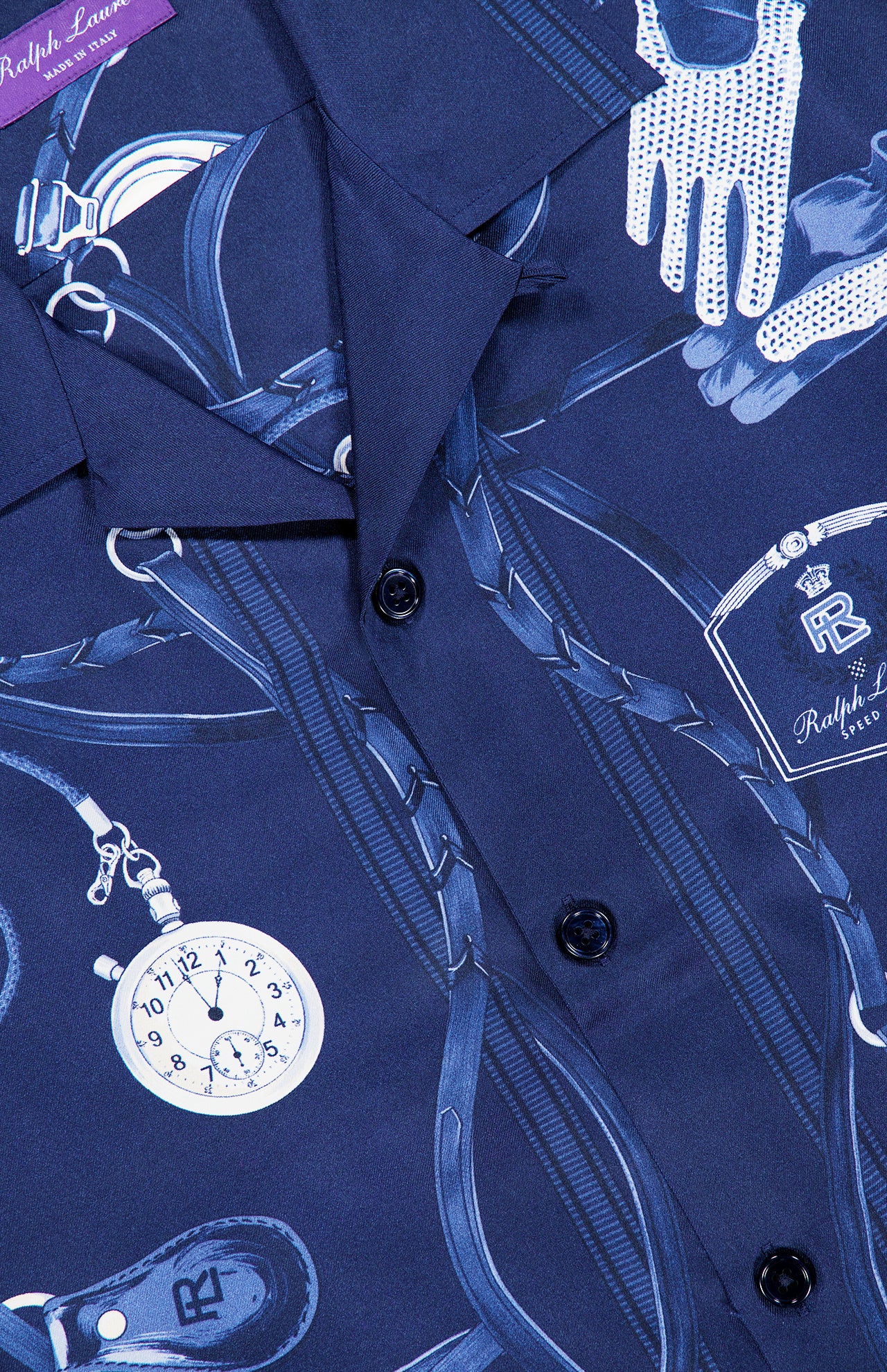 Close-up of a blue RALPH LAUREN PURPLE LABEL Printed Silk Short Sleeve Sport Shirt, made in Italy, adorned with illustrations of gloves, a stopwatch, a perfume bottle, and straps, and finished with black buttons down the front.