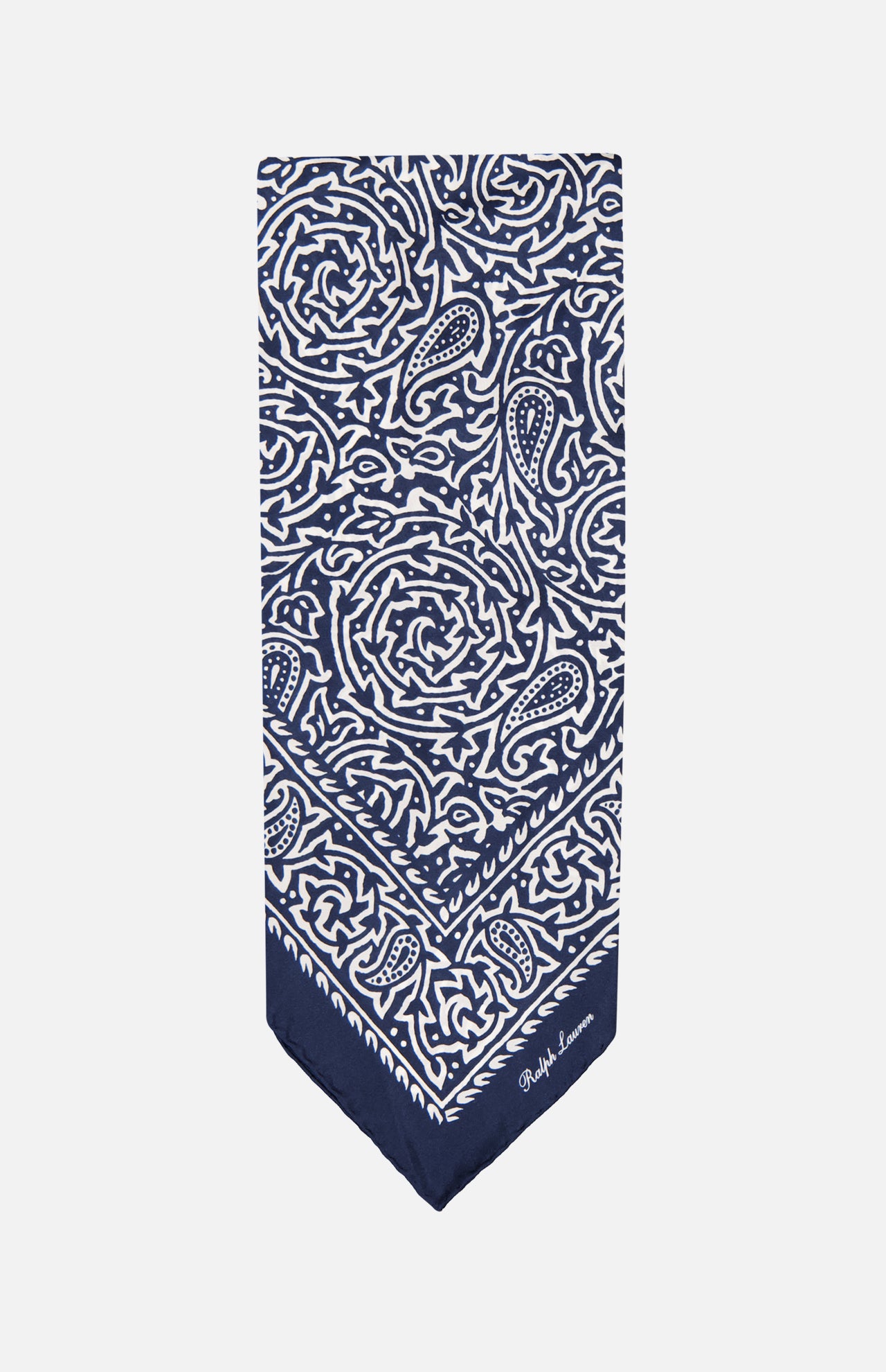The Silk Choppa Scarf by RALPH LAUREN PURPLE LABEL, featuring intricate white paisley and floral patterns on navy blue silk, is neatly folded into a rectangle and displayed against a plain white background. Made in Italy, this elegant neckerchief adds a sophisticated touch to any outfit.