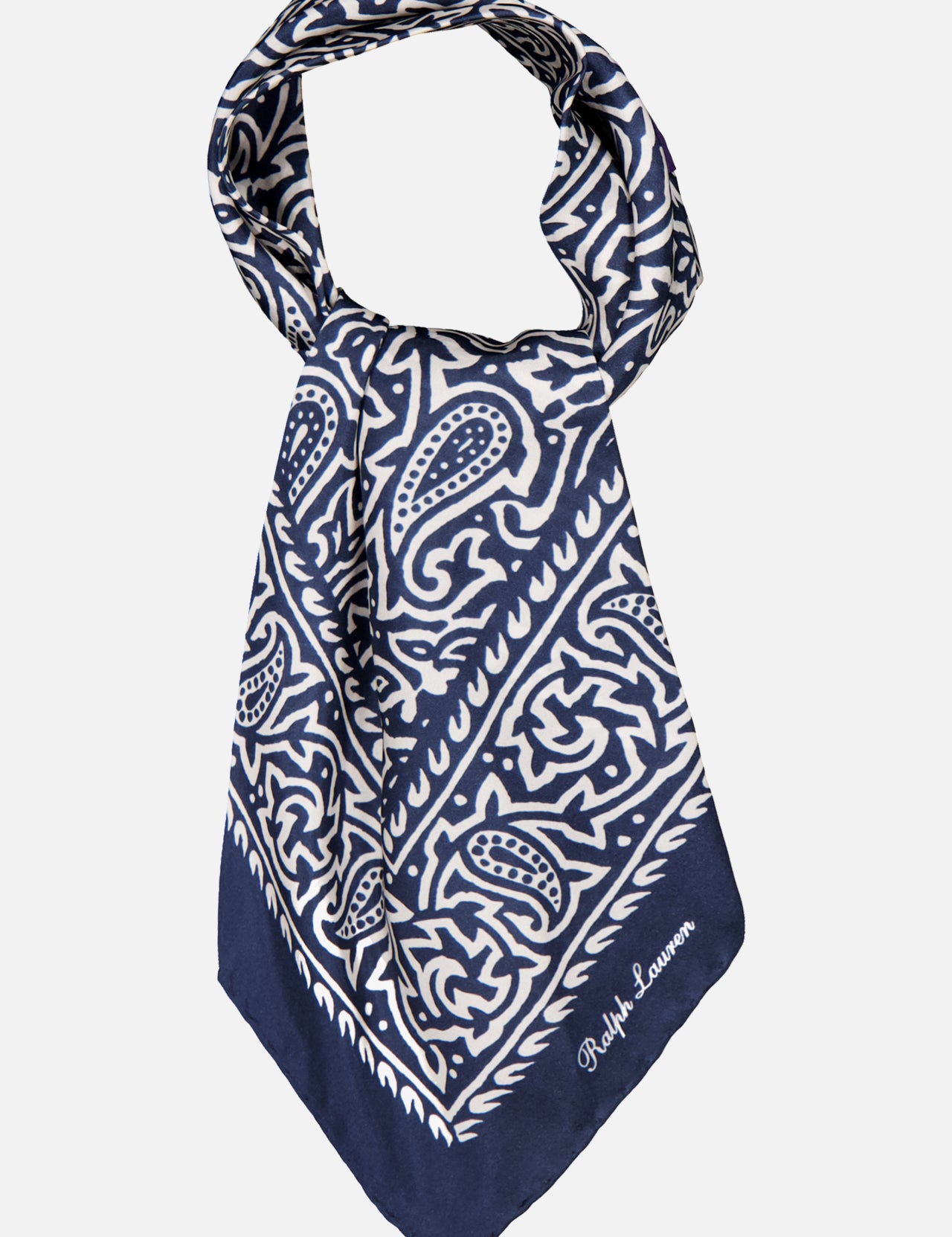 A navy blue and white Silk Choppa Scarf from RALPH LAUREN PURPLE LABEL, featuring intricate paisley and geometric patterns and folded into a triangle. Made in Italy from fine silk as a neckerchief, it is finished with "Ralph Lauren" embroidered in white on one corner.