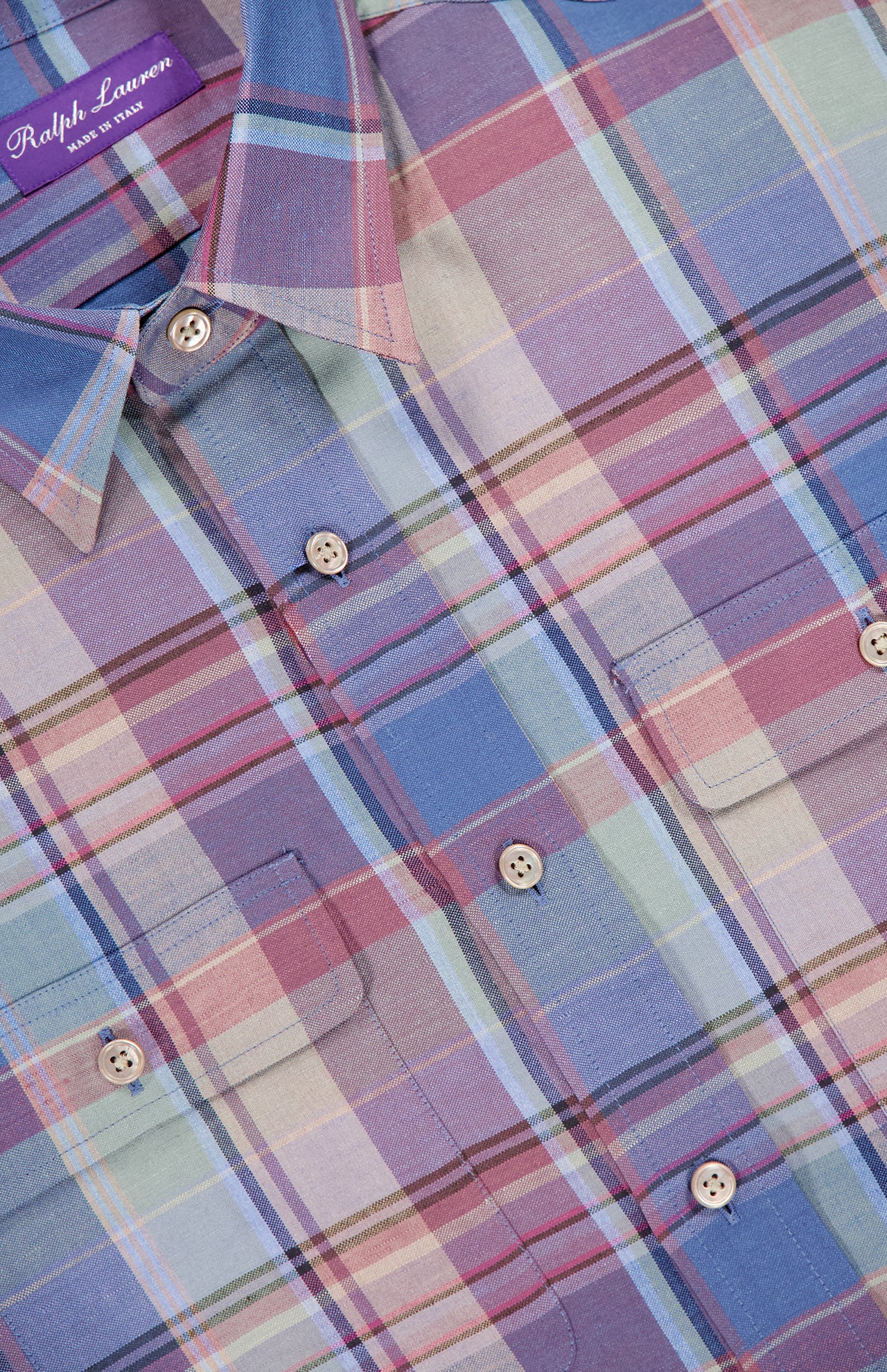 Close-up of the RALPH LAUREN PURPLE LABEL Silk Linen Plaid Sport Shirt, showcasing a pastel plaid pattern in blue, purple, pink, and green with two chest pockets and beige buttons.