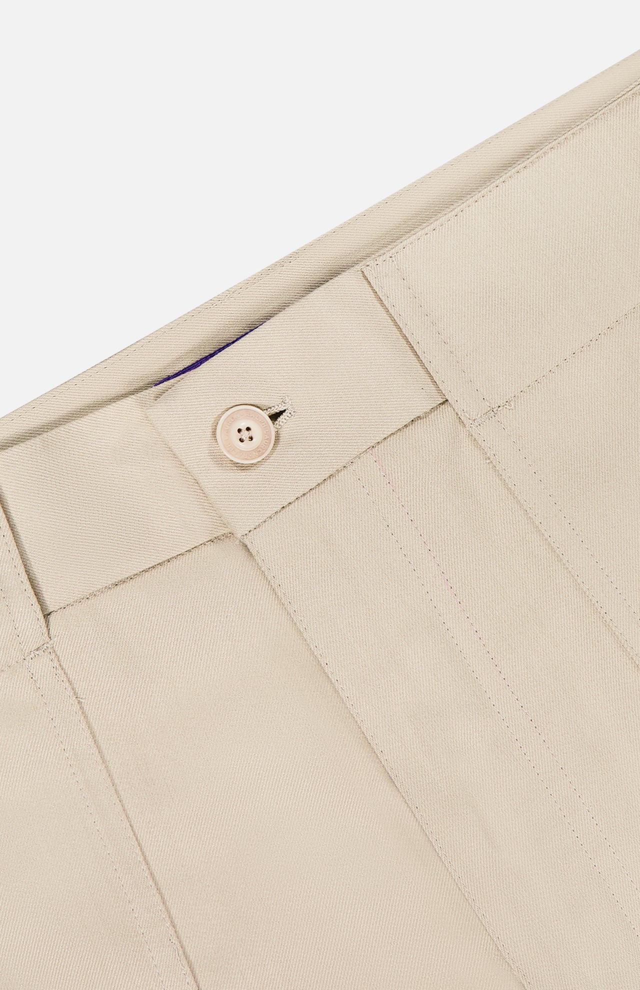 Close-up of the waistband and button closure on the Structured Silk Harold Flat Front Short by RALPH LAUREN PURPLE LABEL, highlighting stitched details and single button on a plain, light background.