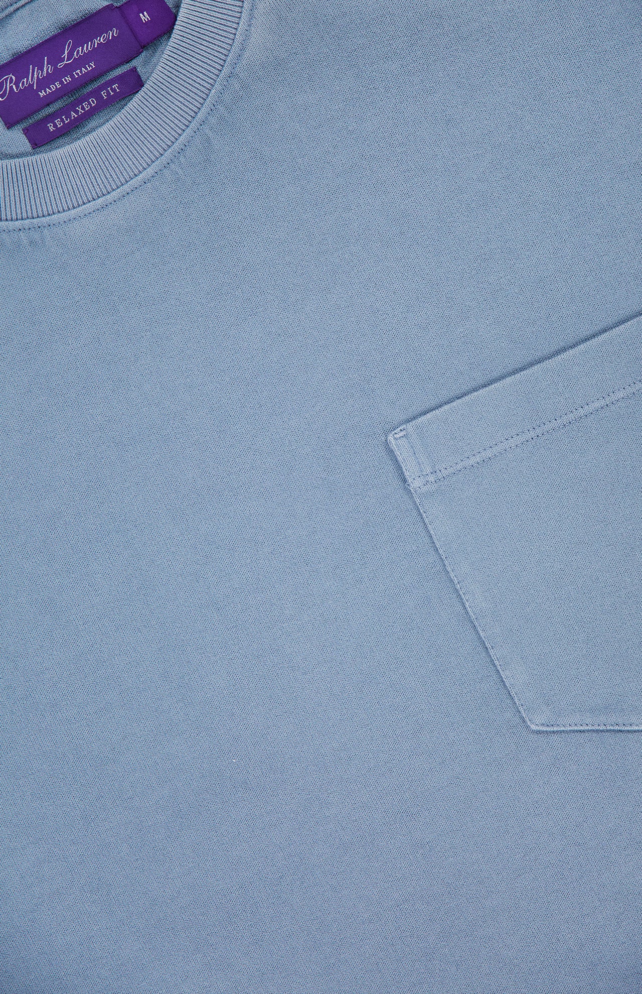 Experience comfort and timeless style in the Vintage Cotton Jersey Short Sleeve T-Shirt from RALPH LAUREN PURPLE LABEL. This light blue crewneck features a soft cotton construction, a classic chest pocket, and a vintage wash for a subtle, lived-in look. The signature purple label inside the collar highlights the brand name and size M.