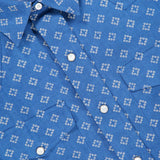 A close-up of the RALPH LAUREN PURPLE LABEL Western Wendover Bandana Sport Shirt, showcasing its rich blue hue reminiscent of indigo, adorned with a crisp white geometric square pattern and accented by white buttons.