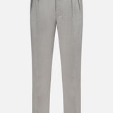 The Wool Flannel Pleated Trouser by RALPH LAUREN PURPLE LABEL features a light gray hue, front pleats, side adjusters, and a straight-leg cut, recalling the timeless elegance of classic Ralph Lauren grey pleated trousers and displayed against a white background.