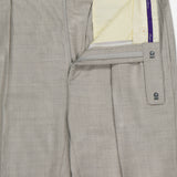 The Wool Flannel Pleated Trouser by RALPH LAUREN PURPLE LABEL is hand-tailored in Italy from light gray wool flannel. Shown with the waistband and fly open, these trousers reveal a cream-colored interior lining and a signature purple label. Finished with pleats, button closure, and belt loops.