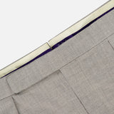 Close-up of the waistband and upper section of the RALPH LAUREN PURPLE LABEL Wool Flannel Pleated Trouser in light gray, highlighting the hook-and-bar closure and inner lining with a purple accent.