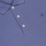 Close-up of a light purple RALPH LAUREN PURPLE LABEL Pique Short Sleeve Polo Shirt, featuring a collar, three white buttons, and a subtle RL logo on the chest. The brand label appears at the neckline. Made in Italy.