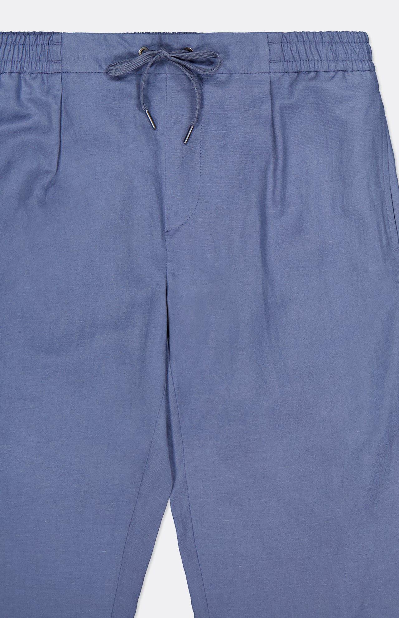 The Ralph Lauren Purple Label Silk Linen Dorset Flat Front Trouser in light blue features a soft, unpatterned fabric, an elastic waistband with drawstring tie, and is shown from waist to mid-thigh.