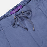 Close-up of light blue Silk Linen Dorset Flat Front Trouser featuring an elastic waistband and a visible purple Ralph Lauren Purple Label.