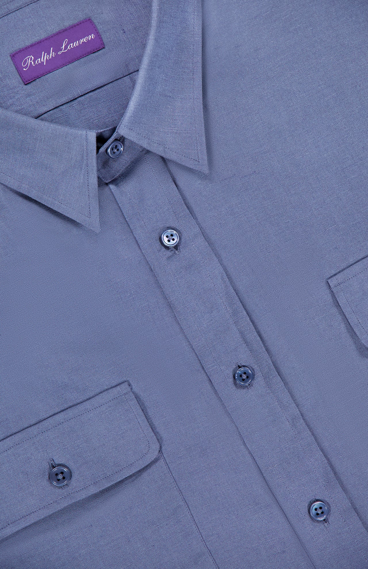 A close-up of a light purple Silk Linen Sport Shirt by Ralph Lauren Purple Label, highlighting the collar, buttons, two chest pockets, and the inner brand label.