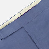 Close-up of the waistband and upper section of the Silk Linen Trouser by Ralph Lauren Purple Label, featuring a light blue hue, white inner lining, and a hook-and-bar closure.