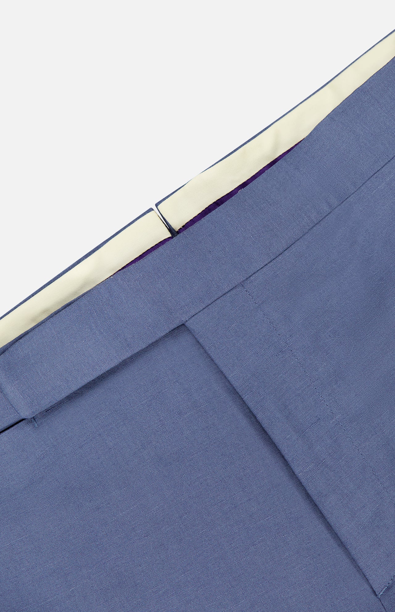 Close-up of the waistband and upper section of the Silk Linen Trouser by Ralph Lauren Purple Label, featuring a light blue hue, white inner lining, and a hook-and-bar closure.