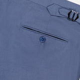 Close-up of the back pocket of Ralph Lauren Purple Label Silk Linen Trouser in light blue, showcasing a single button closure and an adjustable side buckle on the waistband.