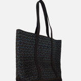 The Cotton Banks Beach Bag by RALPH LAUREN RRL is a large, rectangular navy bag with long black handles and a hand-braided woven pattern in dark blue and black, shown against a plain white background.