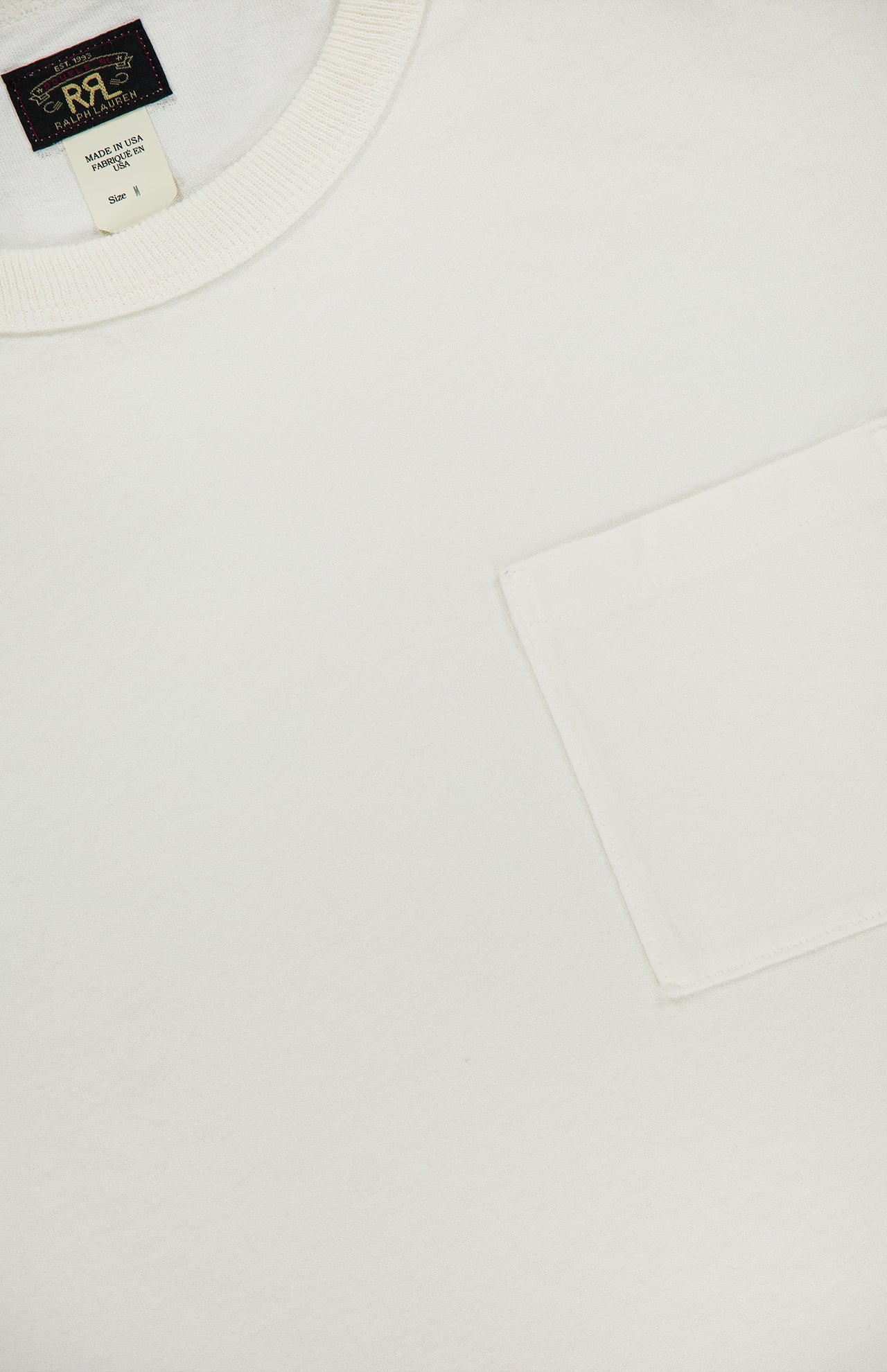 Close-up of a RALPH LAUREN RRL Cotton Jersey Knit Pocket T-Shirt (2 Pack) in vintage white, featuring a right chest pocket and black neckline tag with gold and white text. Made in USA.
