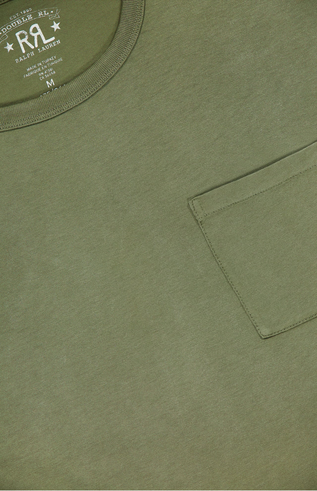 Close-up of the RALPH LAUREN RRL Cotton Jersey Pocket T-Shirt in olive green, featuring garment-dyed cotton, a chest pocket, collar, and an inside neck label with the Double RL logo and medium size.