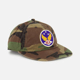 The RALPH LAUREN RRL Cotton Ripstop Printed Camo Ball Hat features a vintage look, round patch with yellow wings, blue background, three stars, red RRL letters, and an adjustable back strap for a perfect fit.