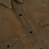 Close-up of the Denim Buffalo Western Shirt by RALPH LAUREN RRL, featuring black snap buttons, two chest pockets, and a metal stud starburst detail near the shoulder.