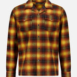 The Jesse Plaid Cotton Camp Shirt by RALPH LAUREN RRL is a long-sleeve button-up shirt crafted from cotton, featuring a vibrant yellow, orange, red, and green plaid pattern. Designed with western-inspired details, it includes two chest pockets with button flaps and a pointed collar, shown against a plain white background.