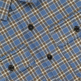 Close-up of the Ralph Lauren RRL Matlock Cotton Long Sleeve Shirt, featuring a blue, brown, and white plaid pattern with two front chest pockets and black buttons. Made from heavyweight cotton twill, this timeless button-up offers a soft, flannel-like texture that evokes vintage appeal.