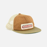 The Roughout Suede Trucker Cap by RALPH LAUREN RRL features a tan and olive color scheme with a rectangular patch on the front displaying “DOUBLE RL” in red and black lettering. This cap includes a curved green waxed canvas bill, an adjustable back strap, and a beige mesh back.
