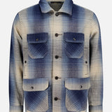 The RALPH LAUREN RRL Ruddic Wool Blend Sport Shirt, shown against a plain white background, features a blue and beige shadow-plaid pattern in wool, a button-down front, two chest flap pockets, and two lower flap pockets.