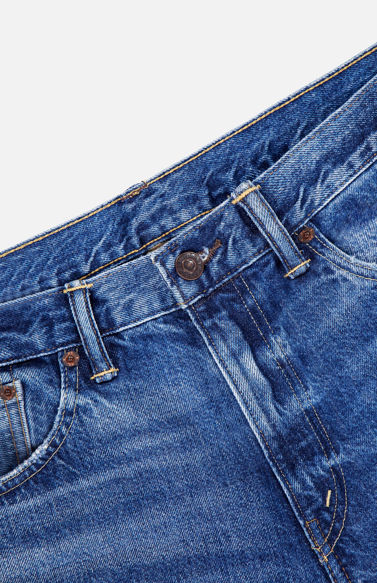 Close-up of the waistband and upper section of the RALPH LAUREN RRL Slim Fit Cotton Denim Jean in Daws Wash, highlighting the button, belt loops, and front pockets in indigo denim on a white background.