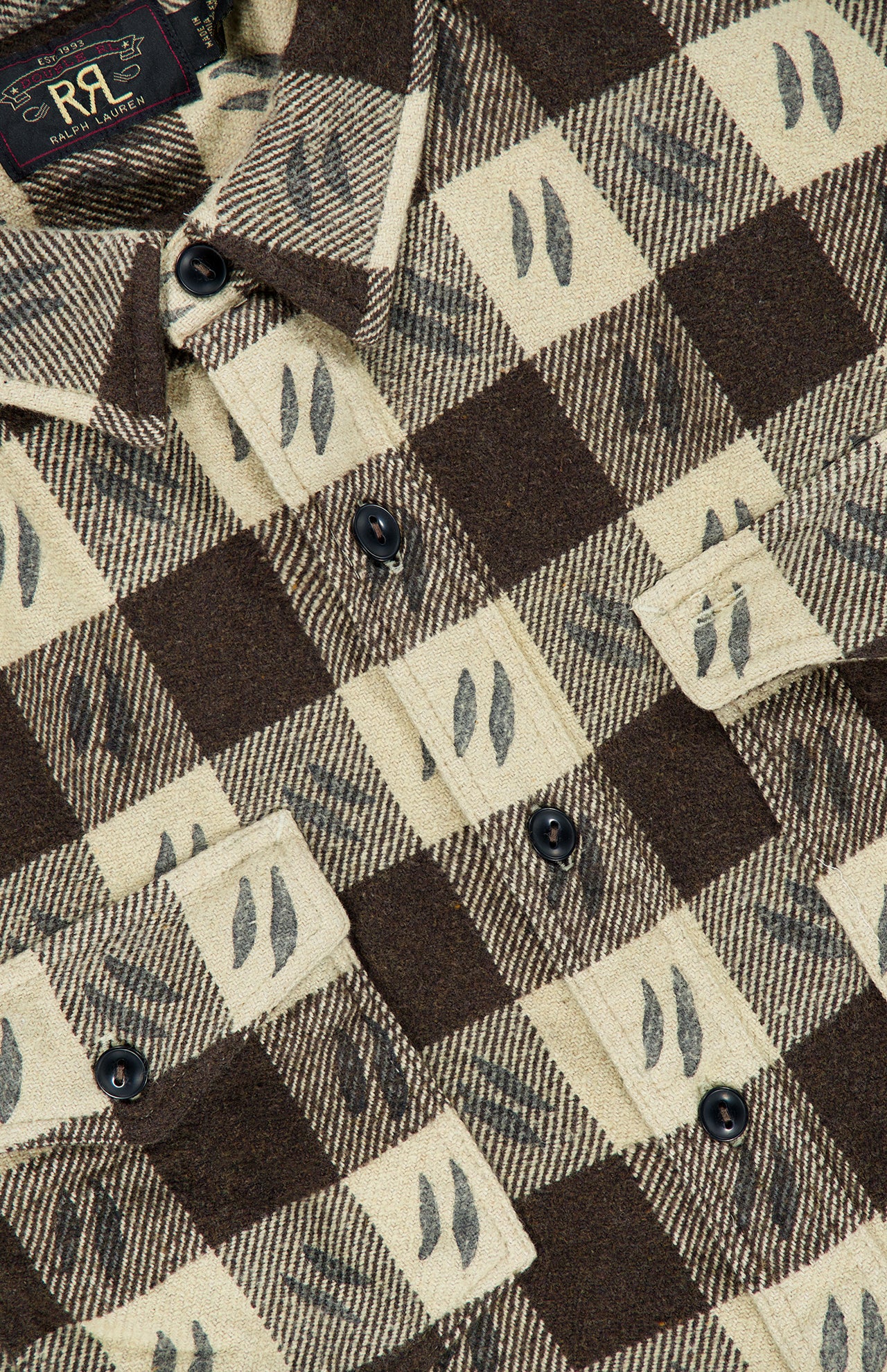 Close-up of a brown and beige plaid Spade Wool Long Sleeve Sportshirt by RALPH LAUREN RRL, featuring black leaf motifs, black buttons, two front pockets, and an RRL tag.