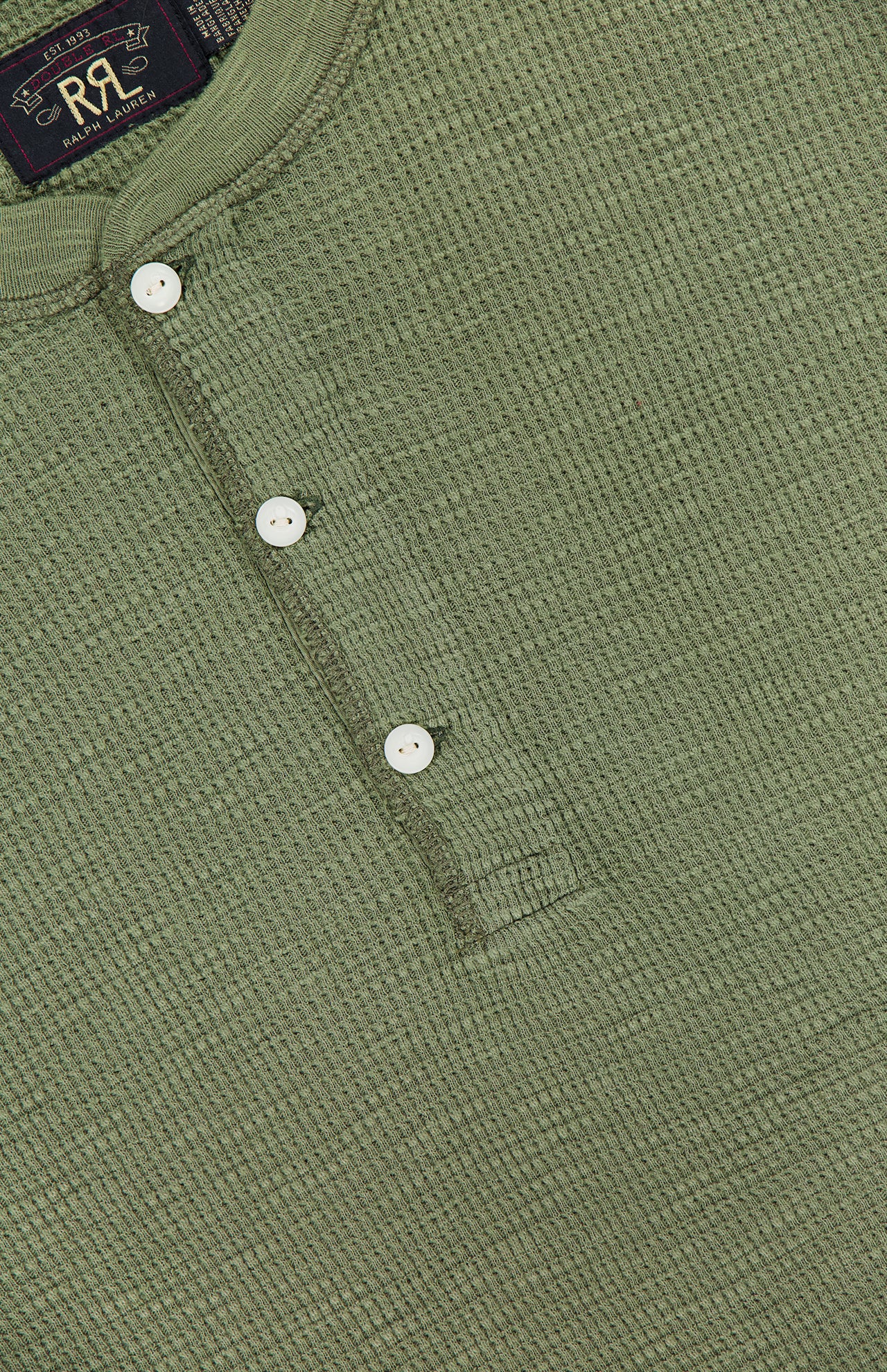 Close-up of the RALPH LAUREN RRL Waffle Knit Long Sleeve Henley Shirt in textured green waffle-knit cotton, featuring four white vintage-inspired buttons and a visible label at the neckline.