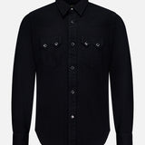 The RALPH LAUREN RRL Western Denim Sawtooth Workshirt is a black, long-sleeve button-up shirt featuring a pointed collar and silver buttons down the front and on the two chest pockets, each with a flap and button closure. Inspired by classic Western shirt design, it is photographed against a plain white background.