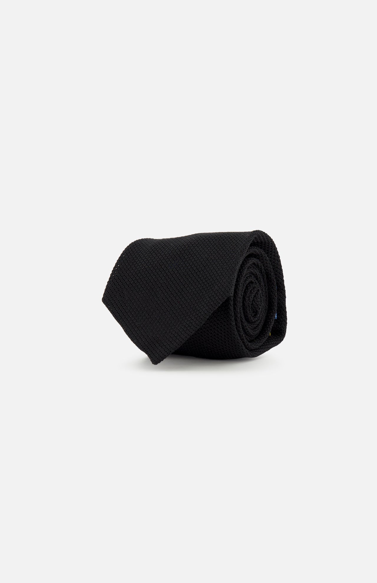 A black silk ROBERT TALBOTT Duvall Grenadine Unlined Tie rolled into a coil.