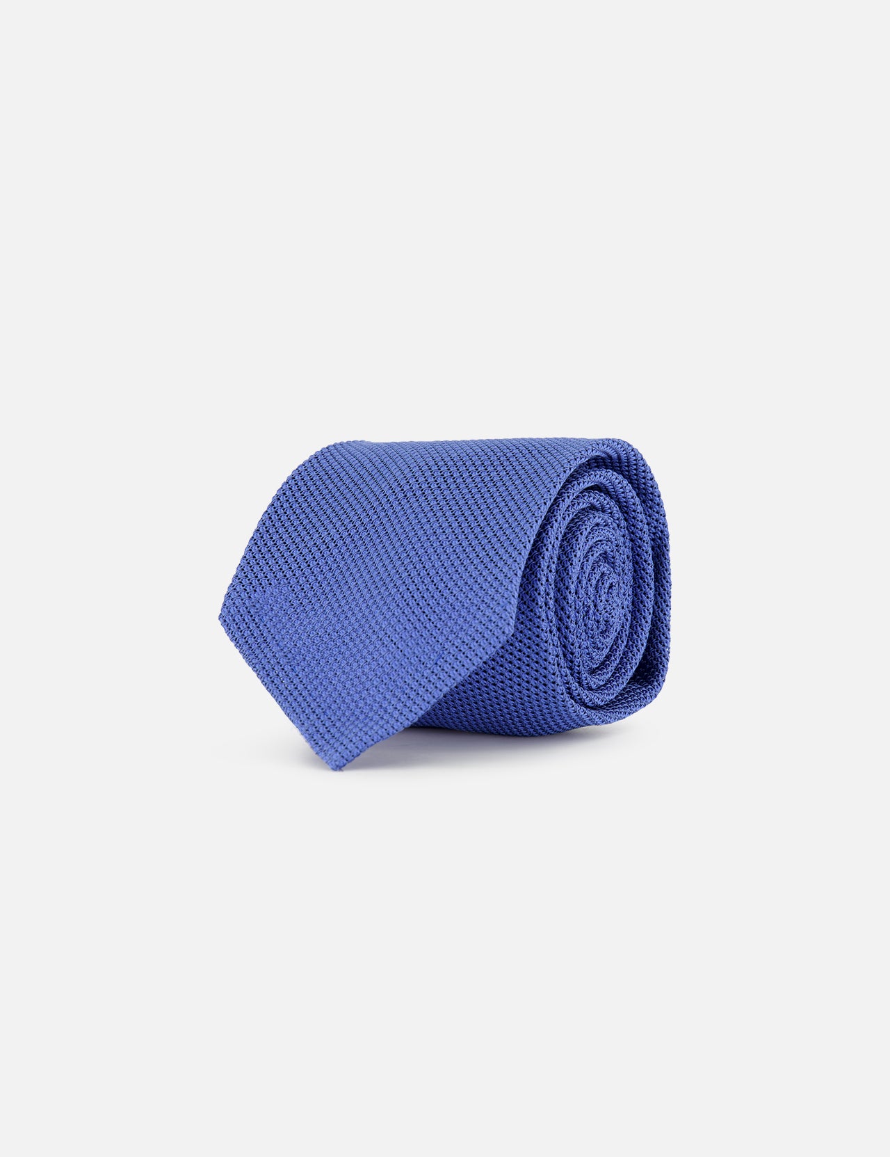 The Duvall Grenadine Unlined Tie by ROBERT TALBOTT, featuring a textured blue silk design, is shown rolled up on a plain white background.