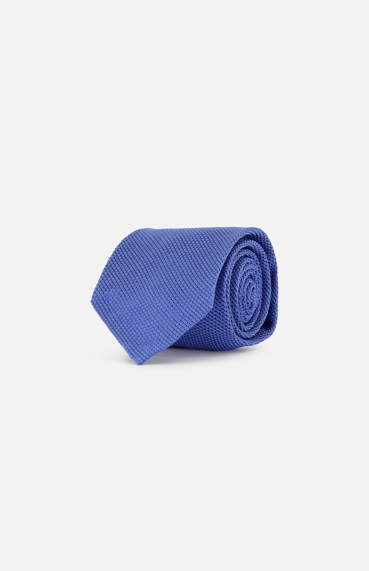 The Duvall Grenadine Unlined Tie by ROBERT TALBOTT, featuring a textured blue silk design, is shown rolled up on a plain white background.