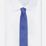 A crisp white dress shirt with a pointed collar is styled with the ROBERT TALBOTT Duvall Grenadine Unlined Tie in blue, set against a white background.